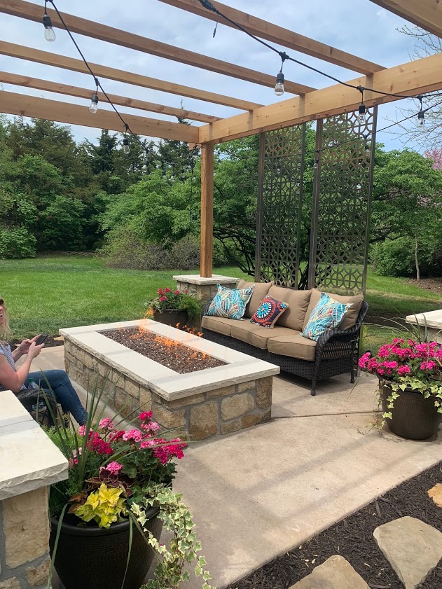 A colorful patio space with a custom fireplace