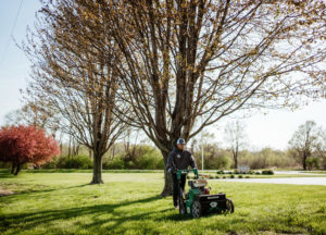 Schendel worker seeding a lawn in the fall