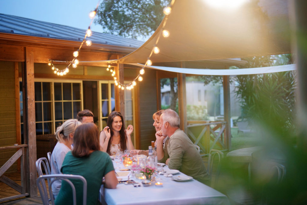 Family around a dinner table outside