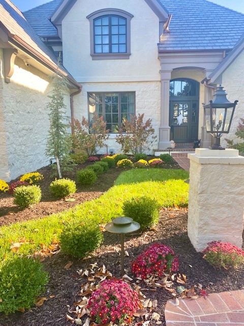 A front landscape with bushes on mulched landscape beds
